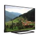 Vestel 48FA7500 Full HD LED televizyon, siyah çerçeveli ekranında dağ köyü manzarası gösteriyor