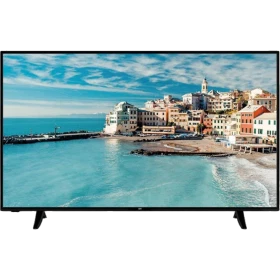 SEG 55SBU710 Ultra HD 4K LED televizyon, sahil manzarası gösteren siyah ekranı ve ayaklarıyla önden görünüm