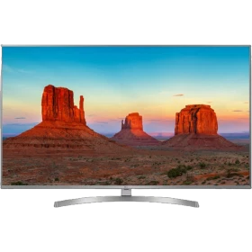 LG 49UK7550PLA Ultra HD 4K LED TV, gökyüzü manzaralı ekranda oturma sehpası üzerinde gösterim