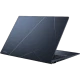 Asus Zenbook 14 UX3402VA-KP659W koyu mavi ultrabook laptop, kapağı açık ve ışıklı tasarım detaylarıyla.