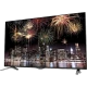 LG 55UB830V Ultra HD 4K LED televizyon ekranında gece şehir manzarası ve renkli havai fişekler görünüyor.