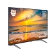 Grundig 65 GJU 7100 Ultra HD 4K LED TV, sahil manzarası gösteren ekranı ve ayaklı tasarımıyla