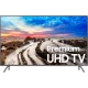 Samsung 82MU8000 Ultra HD 4K LED televizyon; plaj manzarası ekranda, vitrinde şık siyah tasarım.