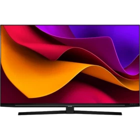 Arçelik A65 C 985 B Ultra HD 4K LED televizyon, renkli ekranı ve siyah tasarımıyla masaya kurulmuş halde