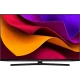 Arçelik A65 C 985 B Ultra HD 4K LED televizyon, renkli ekranı ve siyah tasarımıyla masaya kurulmuş halde