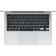 Apple MacBook Air M3 13.6 inç gümüş laptop, üstten görünümde siyah klavye ve geniş trackpad detayıyla