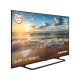 Grundig Madrid 65 GJQ 9250 Ultra HD 4K QLED LED televizyon, siyah çerçeveli ve plaj manzarası ekranlı